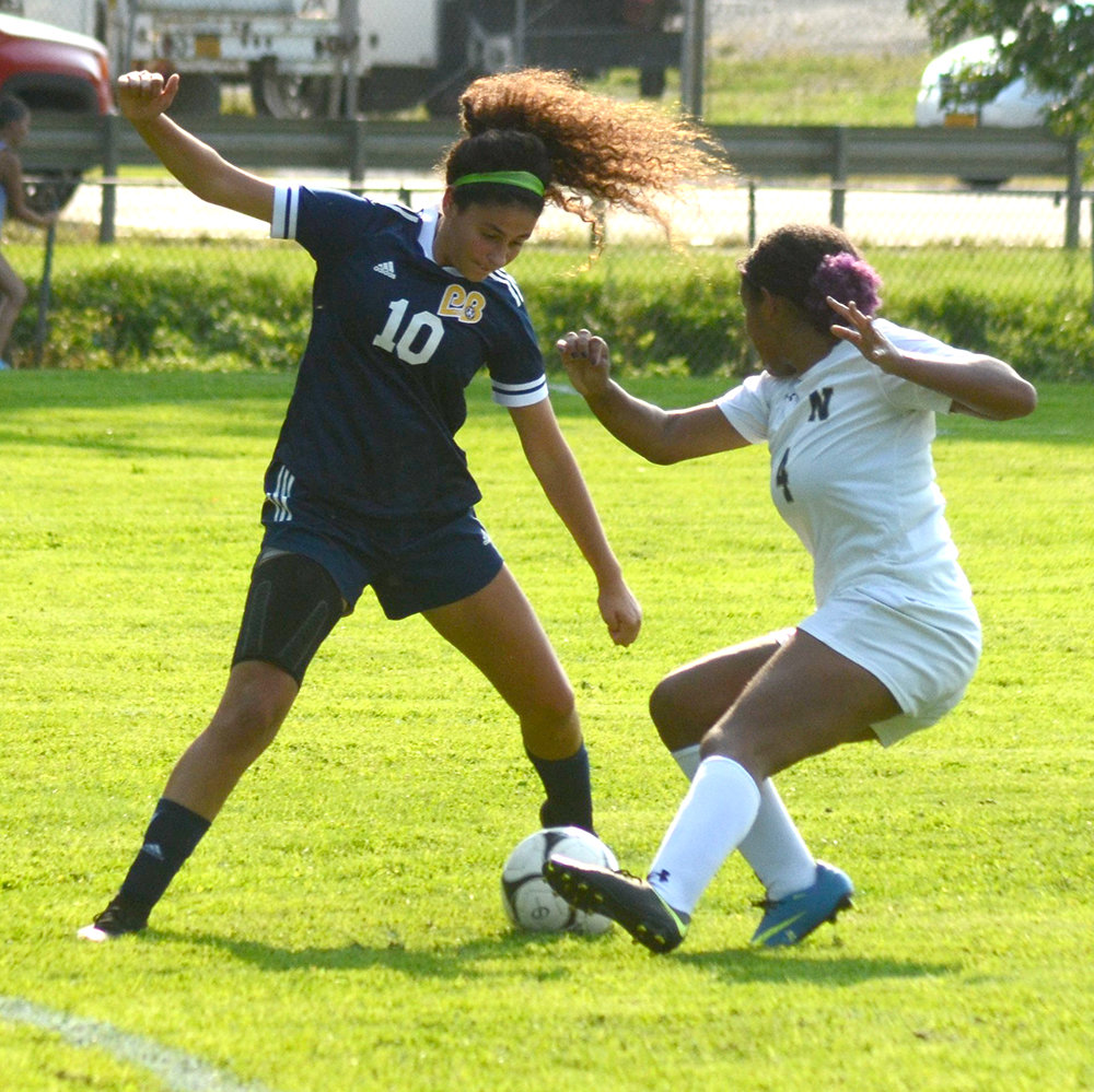 Pine Bush’s Cambryn Brown battles Newburgh’s Angela Holness for the ball during an OCIAA girls’ soccer game on Sept. 13.